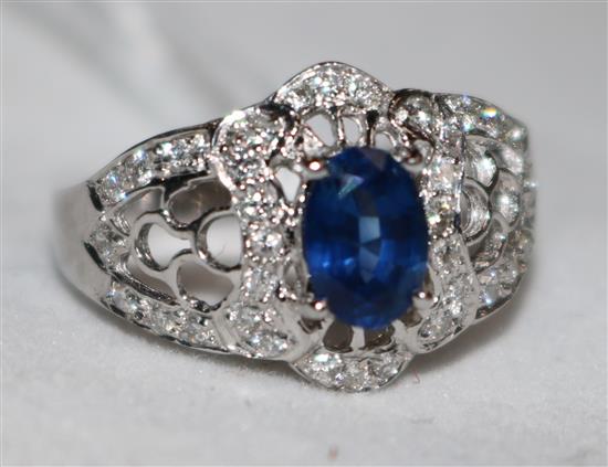 An 18ct white gold, sapphire and diamond ring, size H.